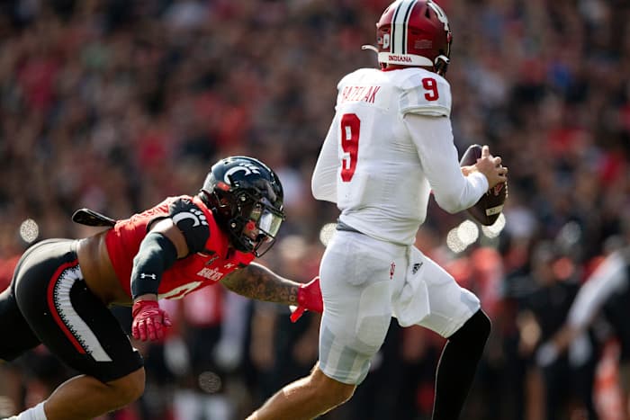 Cincinnati Bearcats linebacker Ivan Pace Jr. (0) dives toward Indiana Hoosiers quarterback Connor Bazelak (9) for a sack during the first quarter of the NCAA football game between the Cincinnati Bearcats and the Indiana Hoosiers at Nippert Stadium, Saturday, Sept. 24, 2022. Syndication The Enquirer
